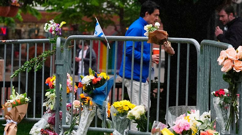 FILE - Bouquets of flowers stand along a makeshift memorial for victims of an attack outside of the Boulder County courthouse on June 3, 2025, in Boulder, Colo. (AP Photo/David Zalubowski, file)