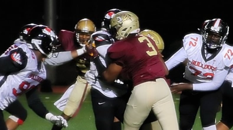 Tucker defensive player Dawson Rivers (3) helps on a sack of Mt. Zion quarterback Ty Rogers.