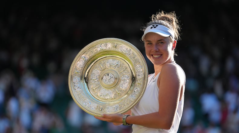 Linda Noskova of Czech Republic poses with the trophy after winning against Karolina Muchova of Czech Republic in the women's singles final at Wimbledon Tennis Championships in London, Saturday, July 11, 2026. (AP Photo/Kirsty Wigglesworth)