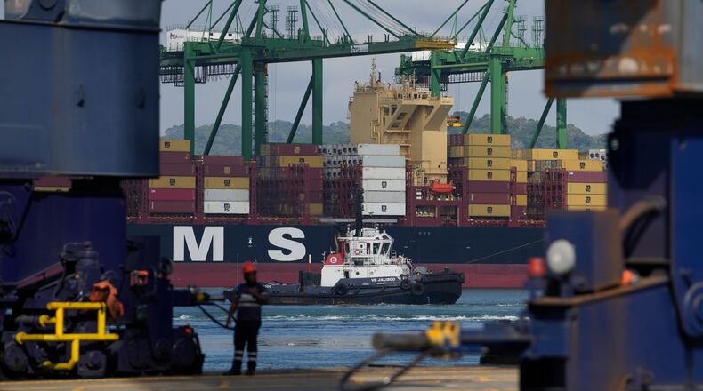 Cranes load and unload containers from cargo ships at the Panama Canal's Rodman Port, operated by PSA International, in Panama City, Thursday, April 9, 2026. (AP Photo/Matias Delacroix)