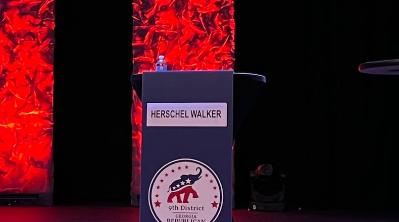 An image of Herschel Walker’s empty podium at the 9th District GOP debate in Gainesville.