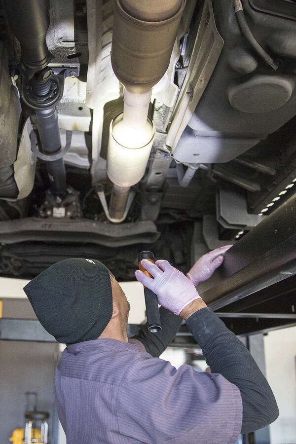 A local mechanic works on an ambulance in an Atlanta-area garage. (Alyssa Pointer/Atlanta Journal Constitution)