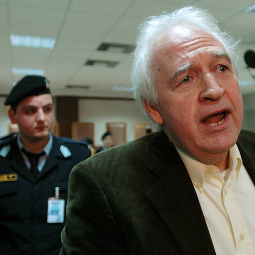 FILE- Convicted leader of the armed group November 17, Alexandros Giotopoulos speaks to reporters, at a special court in a top-security Athens jail, on Dec. 2, 2005. (AP Photo/Thanassis Stavrakis, File)