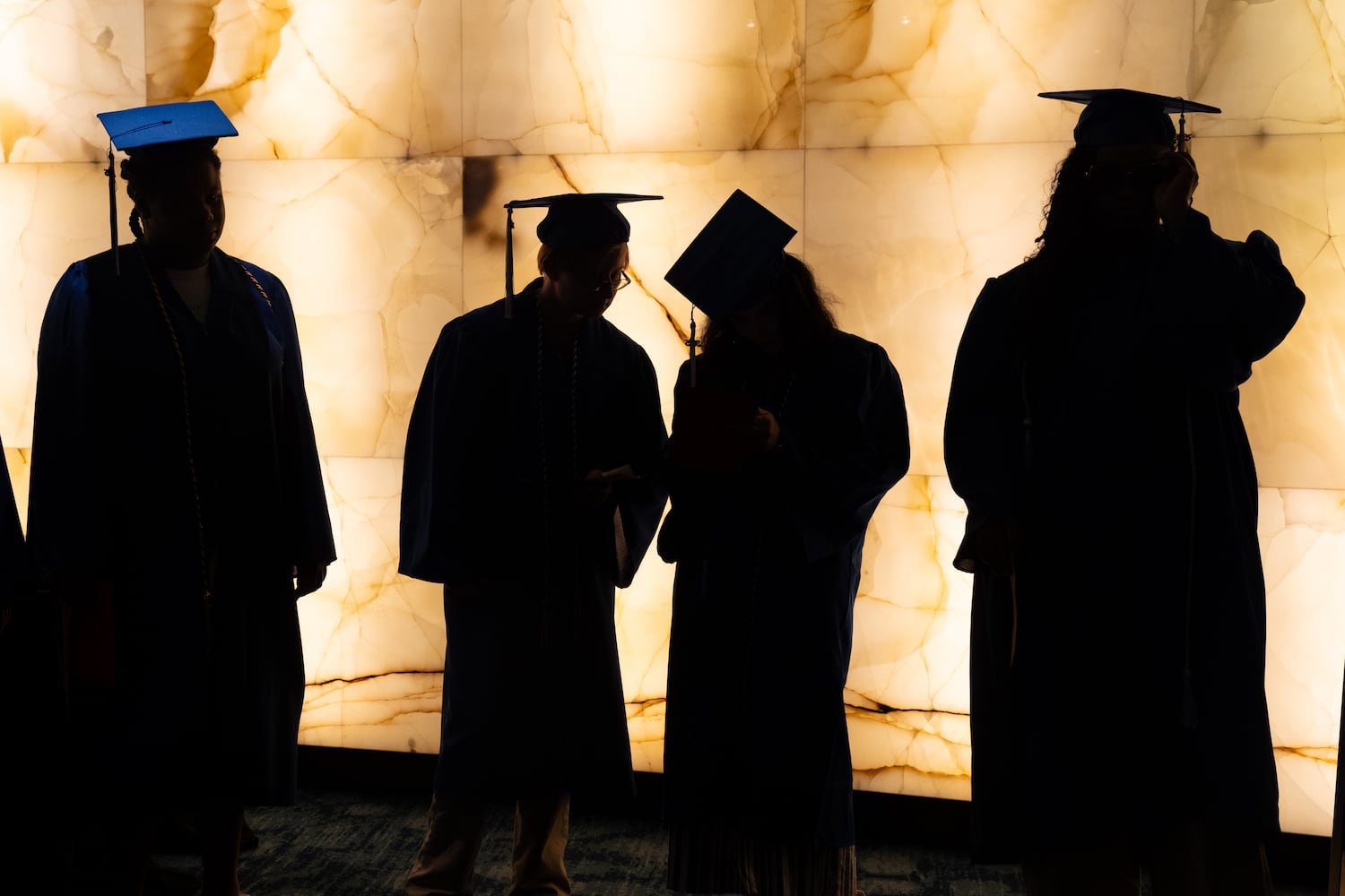Graduates of Goodwill of North Georgia job training program and career development programs line up for a graduation ceremony at the Georgia Aquarium in Atlanta on Monday, June 9, 2025.   Ben Gray for the Atlanta Journal-Constitution