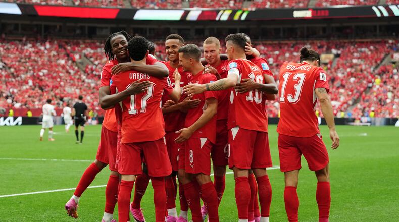 Switzerland's Ruben Vargas (17) is mobbed by teammates after scoring their first goal during the World Cup Group B soccer match between Switzerland and Canada in Vancouver, British Columbia, Wednesday, June 24, 2026. (Ethan Cairns/The Canadian Press via AP)