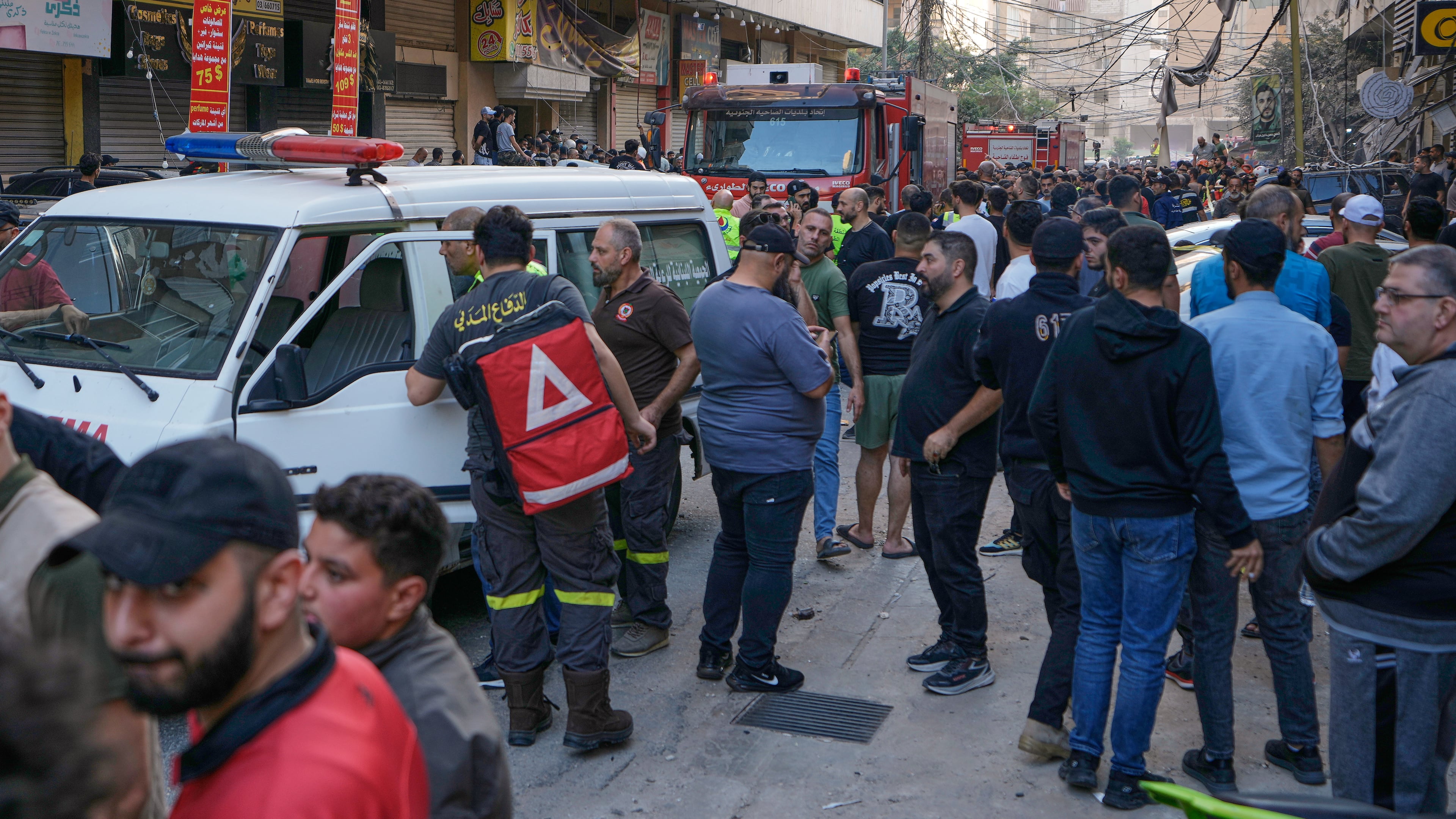 People and Civil Defence workers gather at the site where an Israeli airstrike hit an apartment building on Dahiyeh in the southern suburb of Beirut, Sunday Nov. 23, 2025. (AP Photo/Bilal Hussein)