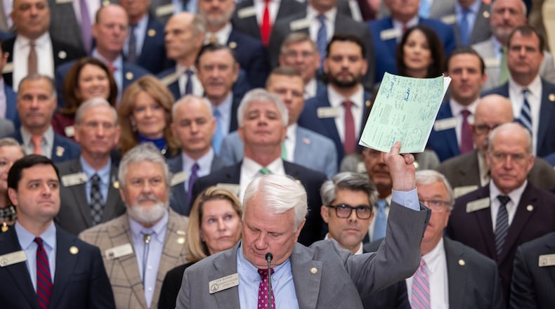 House Speaker Jon Burns holds up proposed property tax relief legislation during a press conference at the Capitol in Atlanta on Wednesday, Jan. 28, 2026. (Arvin Temkar /Atlanta Journal-Constitution via AP)