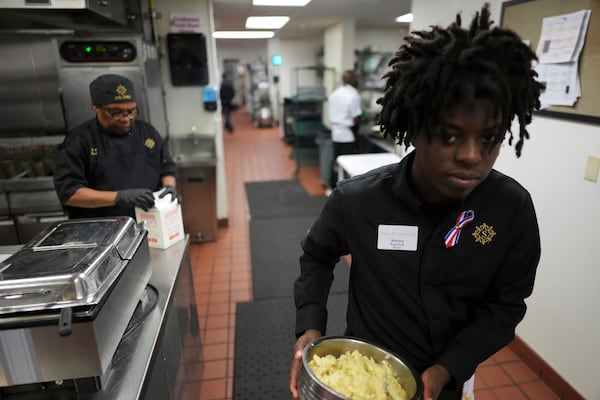 Dining room and kitchen staff work during an Independence Day buffet service, in the independent living facility at the Toby and Leon Cooperman Sinai Residences, July 4, 2025, in Boca Raton, Fla. (AP Photo/Rebecca Blackwell)
