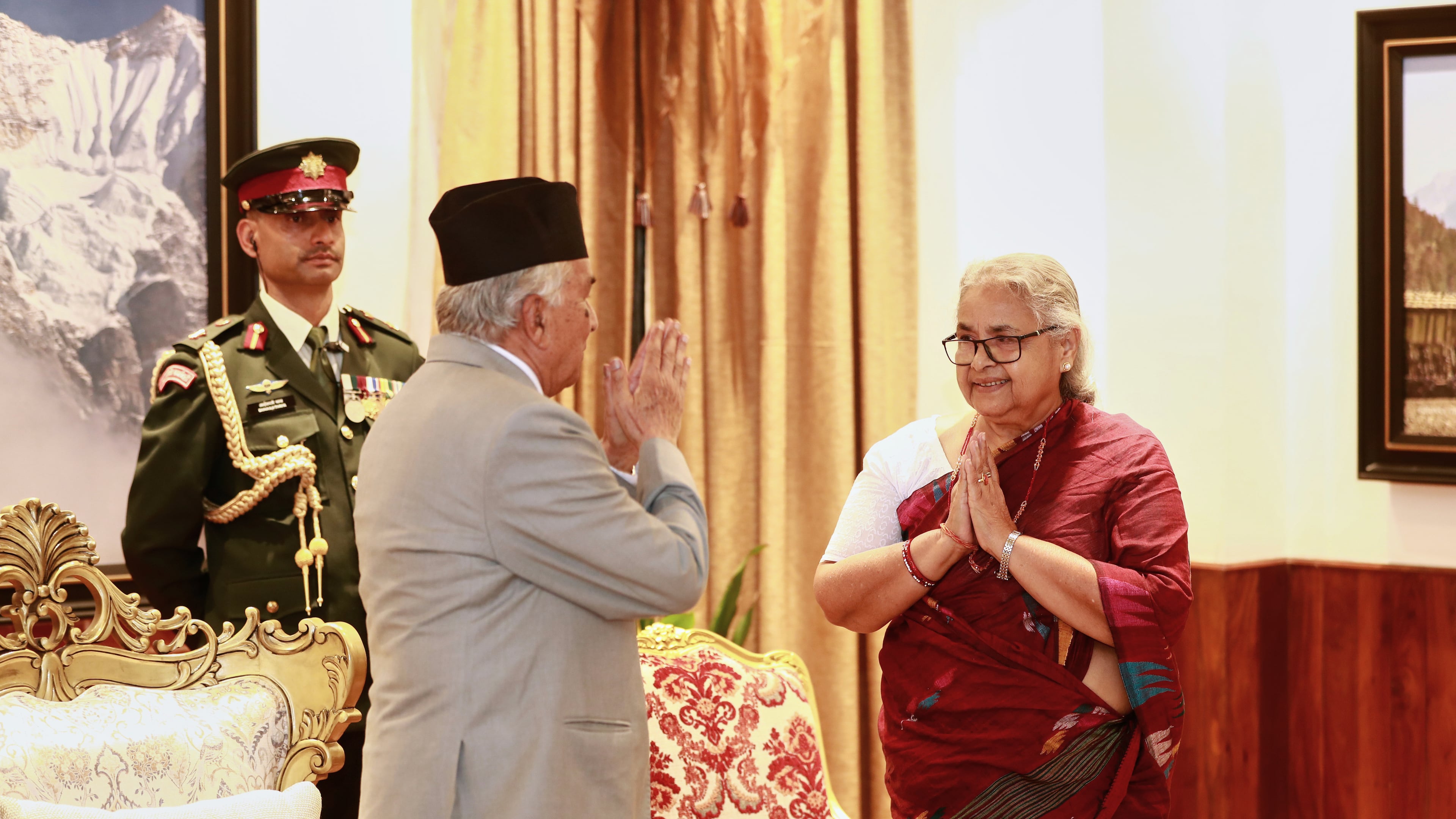 Former Supreme Court Chief Justice Sushila Karki, right, greets Nepalese President Ram Chandra Poudel after taking the oath as interim prime minister during a ceremony at the presidential residence in Kathmandu, Nepal, Friday, Sept. 12, 2025. (AP Photo/Sujan Gurung)