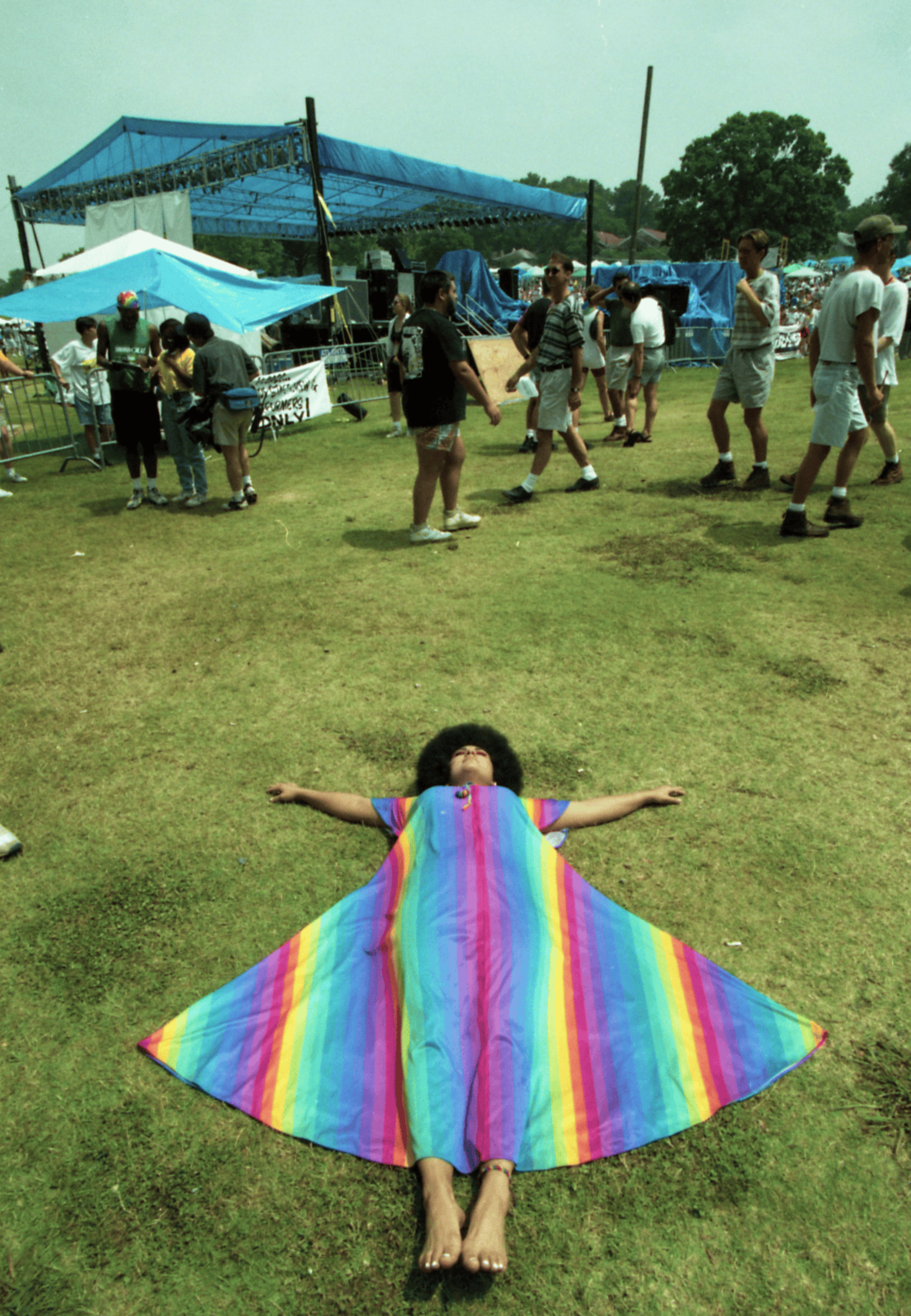 Nalda Rodriguez, wearing a rainbow dress and lying on the grass at the 25th annual Gay Pride celebration, Piedmont Park, Atlanta, Georgia, June 25, 1995. (Atlanta Journal-Constitution Photographic Archives. Special Collections and Archives, Georgia State University Library.)