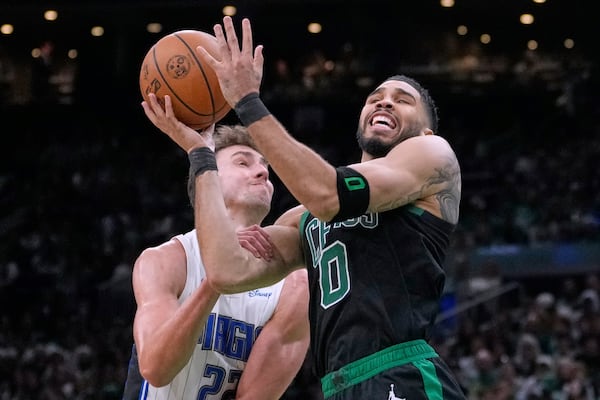 Boston Celtics forward Jayson Tatum (0) is fouled by Orlando Magic forward Franz Wagner (22) on a drive to the basket during the second half in game 5 of a first-round NBA playoff basketball series, Tuesday, April 29, 2025, in Boston. (AP Photo/Charles Krupa)