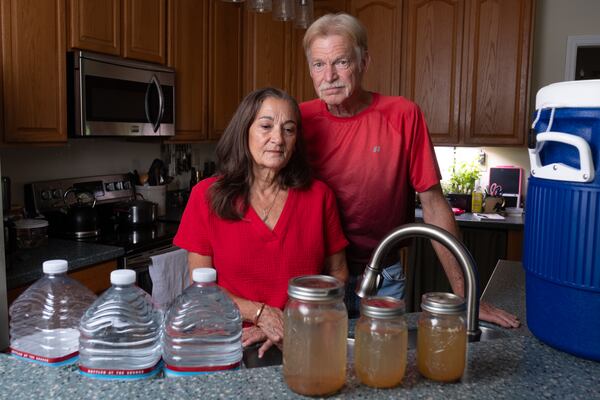 Beverly and Jeff Morris say their well water has been compromised ever since a Meta data center was built across the road from their rural Mansfield home. They now have to bring in 55 gallons of water every day for their two horses and about 50 gallons a month for their own drinking, cooking and cleaning. The mason jars are full of water they collected when flushing out their whole-house water filter recently. (Ben Gray for the AJC)
