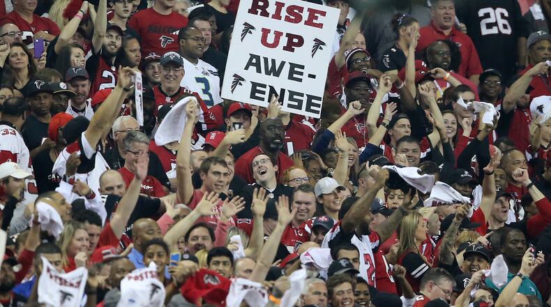 Falcons fans in the Georgia Dome enjoy Saturday’s playoff win over Seattle. Curtis Compton/ccompton@ajc.com