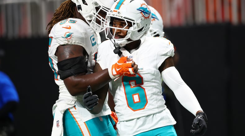 Miami Dolphins wide receiver Malik Washington (6) is congratulated after scoring a touchdown during the first half of an NFL football game against the Atlanta Falcons, Sunday, Oct. 26, 2025, in Atlanta. (AP Photo/Colin Hubbard)