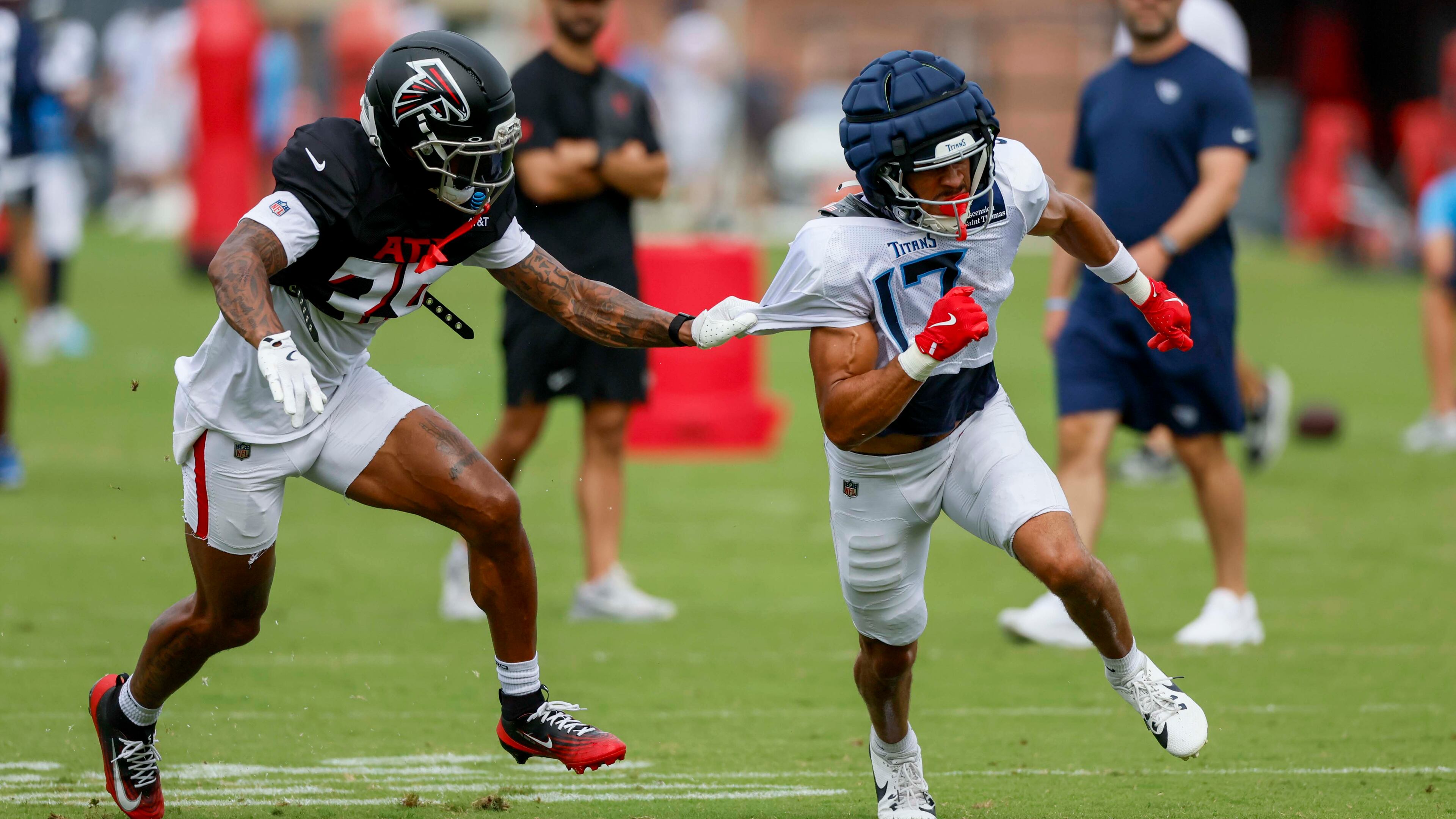 Falcons cornerback A.J. Terrell Jr. (left) pulls the jersey of Titans wide receiver Chimere Dike during the teams’ joint practice on Tuesday, Aug. 12, 2025, in Flowery Branch. The Falcons will open the season with a big NFC South game against the Tampa Bay Buccaneers on Sept. 7 at Mercedes-Benz Stadium. (Miguel Martinez/AJC)