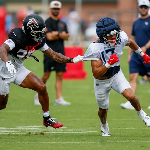 Falcons cornerback A.J. Terrell Jr. (left) pulls the jersey of Titans wide receiver Chimere Dike during the teams’ joint practice on Tuesday, Aug. 12, 2025, in Flowery Branch. The Falcons will open the season with a big NFC South game against the Tampa Bay Buccaneers on Sept. 7 at Mercedes-Benz Stadium. (Miguel Martinez/AJC)