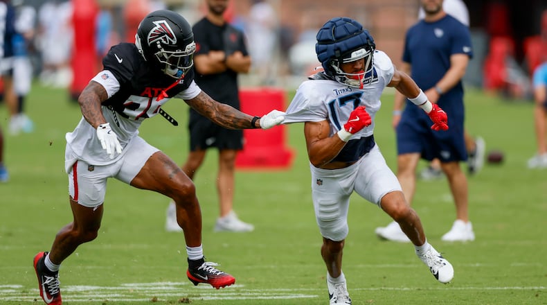 Falcons cornerback A.J. Terrell Jr. (left) pulls the jersey of Titans wide receiver Chimere Dike during the teams’ joint practice on Tuesday, Aug. 12, 2025, in Flowery Branch. The Falcons will open the season with a big NFC South game against the Tampa Bay Buccaneers on Sept. 7 at Mercedes-Benz Stadium. (Miguel Martinez/AJC)