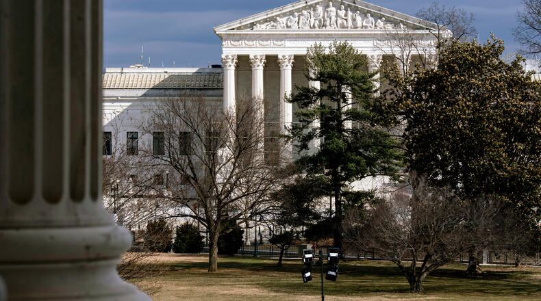 FILE - The Supreme Court is seen in the distance, framed through columns of the U.S. Senate at the Capitol in Washington, Feb. 20, 2025. (AP Photo/J. Scott Applewhite, File)