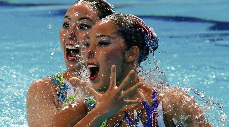 Risako Mitsui, front, and Yukiko Inui perform their duet technical routine at the FINA World Championships in Kazan, Russia, in July. They hope to win a medal for Japan in the 2016 Olympics.