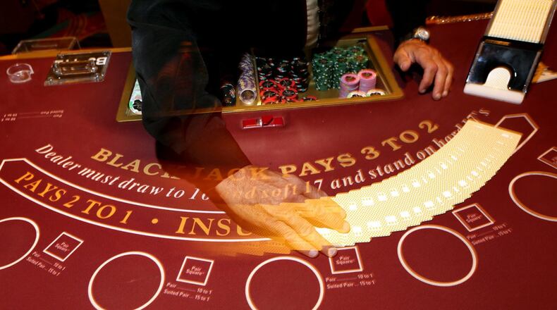 David Delp, a table games dealer, shuffles cards at a blackjack table at the Hollywood Casino in Columbus, Ohio on August 20, 2014. (Columbus Dispatch photo by Brooke LaValley)