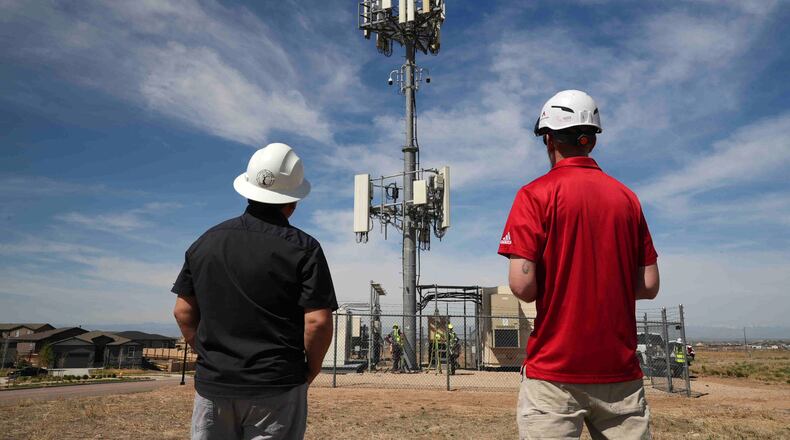 Workers observe a tower where Pano AI cameras are installed for detecting wildfires Monday, April 20, 2026, in Aurora, Colo. (AP photo/Brittany Peterson)