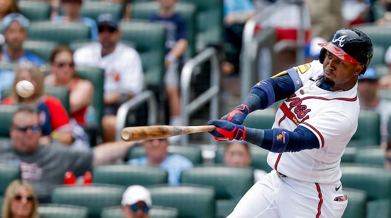 Atlanta Braves' Ozzie Albies hits a double against the New York Mets during the first inning of a baseball game, Sunday, July 5, 2026, in Atlanta. (AP Photo/Erik S. Lesser)