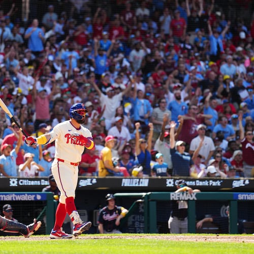 Philadelphia Phillies' Kyle Schwarber, right, watches his solo home run off Atlanta Braves pitcher Dylan Dodd during the seventh inning of a baseball game, Sunday, Sept. 6, 2026, in Philadelphia. (AP Photo/Derik Hamilton)