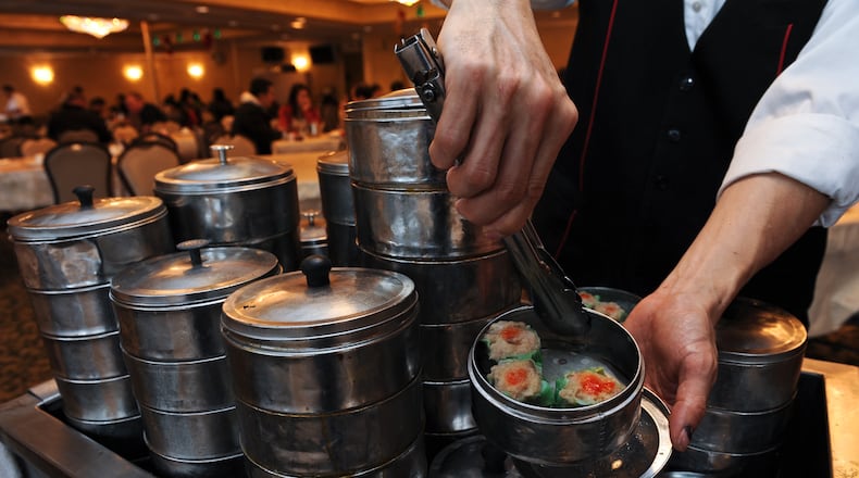A server offers tableside dim sum service at Canton House.