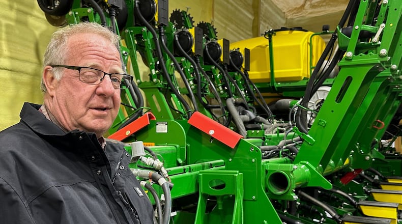 Tom Waters, a seventh-generation farmer, stands next to his planting machinery Friday, March 13, 2026, in Orrick, Mo. (AP Photo/Nick Ingram)