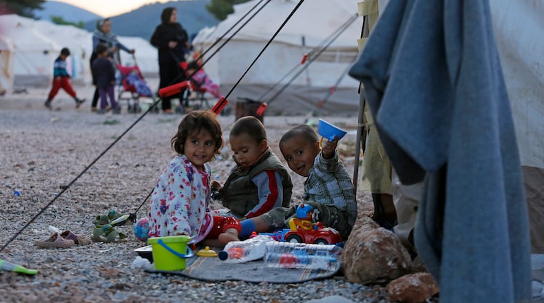 ATHENS, GREECE - MAY 18: Afghan refugee children play outside a tent in a refugee camp on May 18, 2016 in Malakasa, 40km north of Athens, Greece. According to the refugee Crisis Management Coordination Body's figures, 54,574 identified refugeees and migrants are on Greek territory. (Photo by Milos Bicanski/Getty Images)