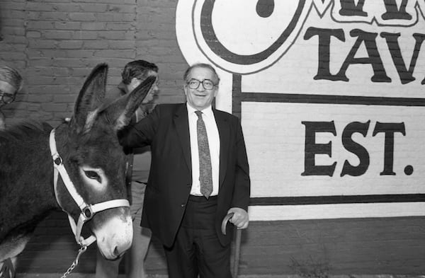Manuel Maloof with donkey outside Manuel's Tavern, part of Maloof's re-election campaign for CEO of DeKalb County. Photo taken October 7, 1987. (Louie Favorite/AJC File)