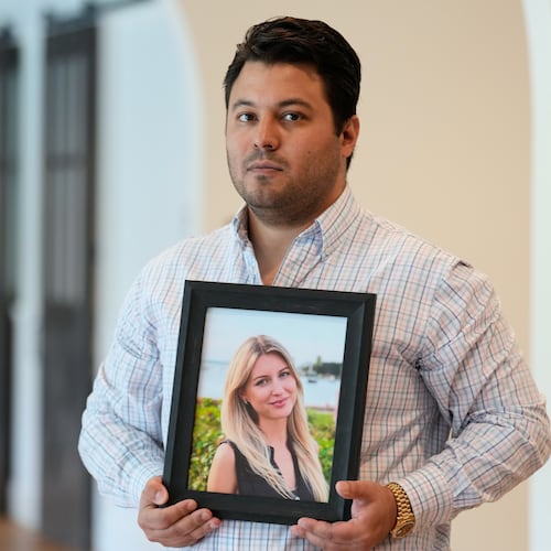 Harold Jezler poses for a picture with a photo of his wife, Olga Jezler, in West Harrison, N.Y., Friday, Aug. 21, 2026. (AP Photo/Seth Wenig)