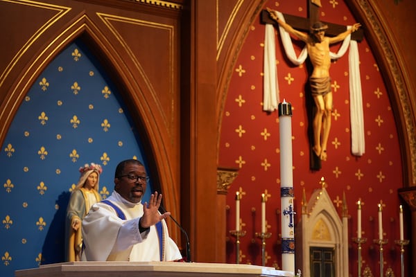 The Rev. Ricky Malebranche speaks to congregants during a Mass at St. Louis Catholic Church in Alexandria, Va., on Saturday, May 24, 2025. (AP Photo/Luis Andres Henao)