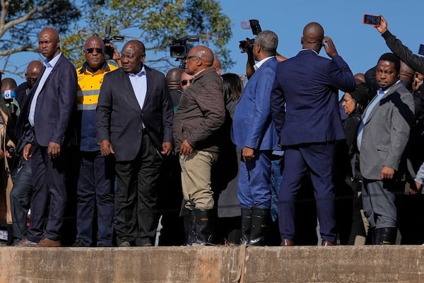 South African President Cyril Ramaphosa, third left, with his officials, visit the flood-affected areas in Mthatha, South Africa, Friday, June 13, 2025. (AP Photo/Themba Hadebe)