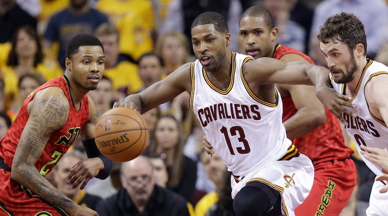 Cleveland Cavaliers’ Tristan Thompson (13) battles Atlanta Hawks’ Kent Bazemore (24), left, and Atlanta Hawks’ Al Horford (15) and Cleveland Cavaliers’ Kevin Love (0) for a rebound in the first half in Game 1 of a second-round series, Monday, May 2, 2016, in Cleveland. (AP Photo/Tony Dejak)