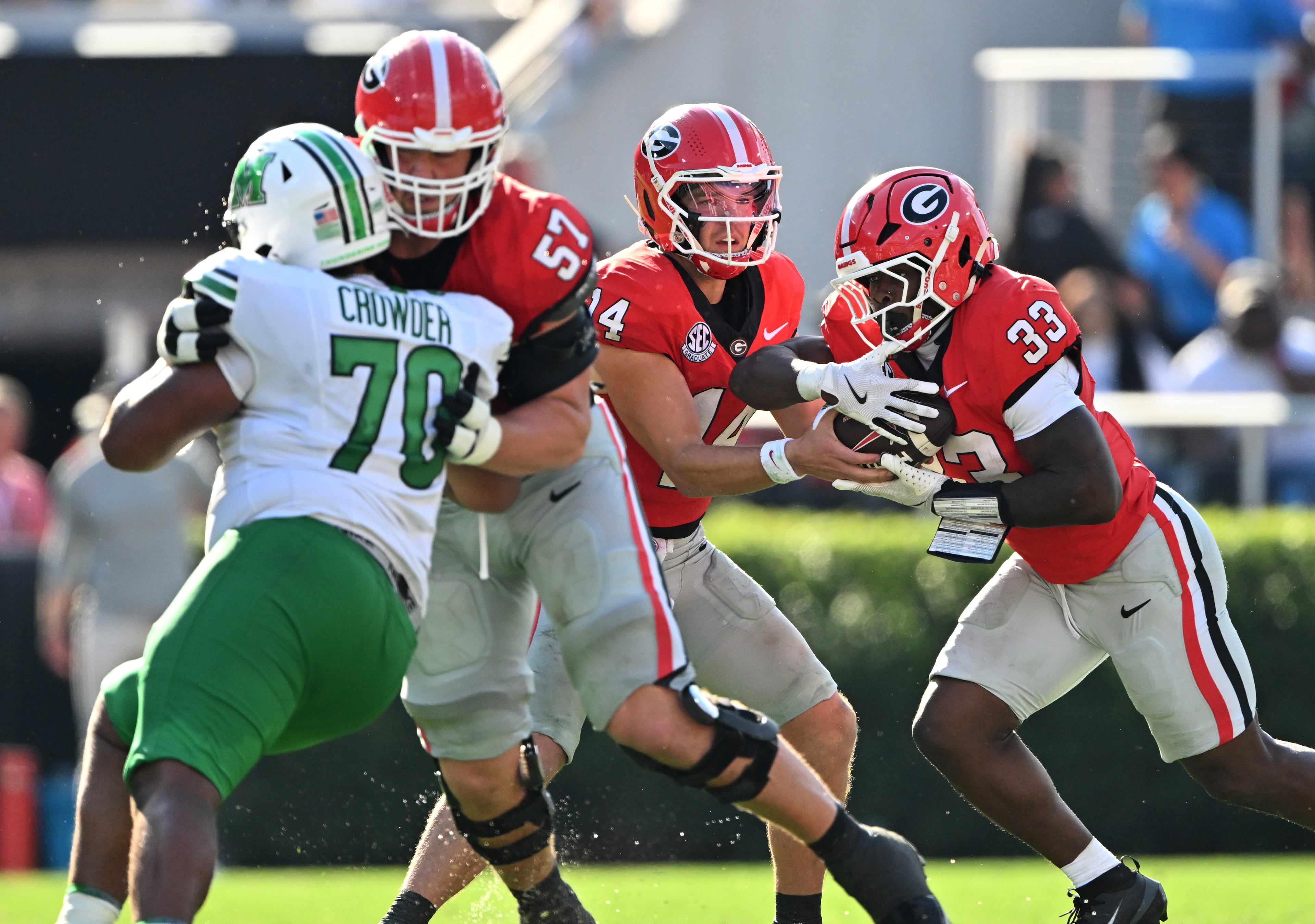 Georgia quarterback Gunner Stockton (14) makes a handoff to Georgia running back Chauncey Bowens (33) during the second half in an NCAA football game at Sanford Stadium, Saturday, August 30, 2025, in Athens. Georgia won 45-7 overMarshall. (Hyosub Shin / AJC)