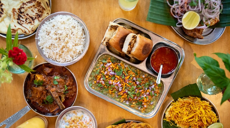 Chai Pani's new menu includes Misal Pav (center), Bengali Fish Fry (upper right), Surti Locho (lower right), Green Tomato Pakora (lower center) and Kolhapuri Mutton (lower left). (Mia Yakel for The Atlanta Journal-Constitution)