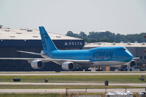 A Korean Air charter plane hangs out at Hartsfield-Jackson International Airport, waiting to take detained South Korean workers out of the U.S. 
