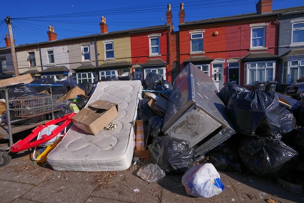 Rubbish piles up on a residential street in Birmingham, England, Monday, April 7, 2025, amid an ongoing refuse workers' strike in the city. (AP Photo/Kirsty Wigglesworth)