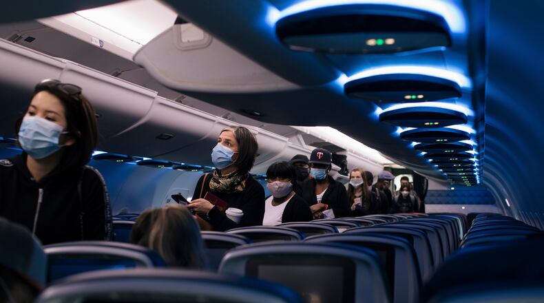 FILE — Passengers board a Delta Air Lines flight at Baltimore-Washington International Airport, June 1, 2020. Delta has tried to stake a claim as one of the most cautious companies in the industry by promising to leave middle seats empty even as its biggest rivals are selling as many seats as they can. (Alyssa Schukar/The New York Times)..