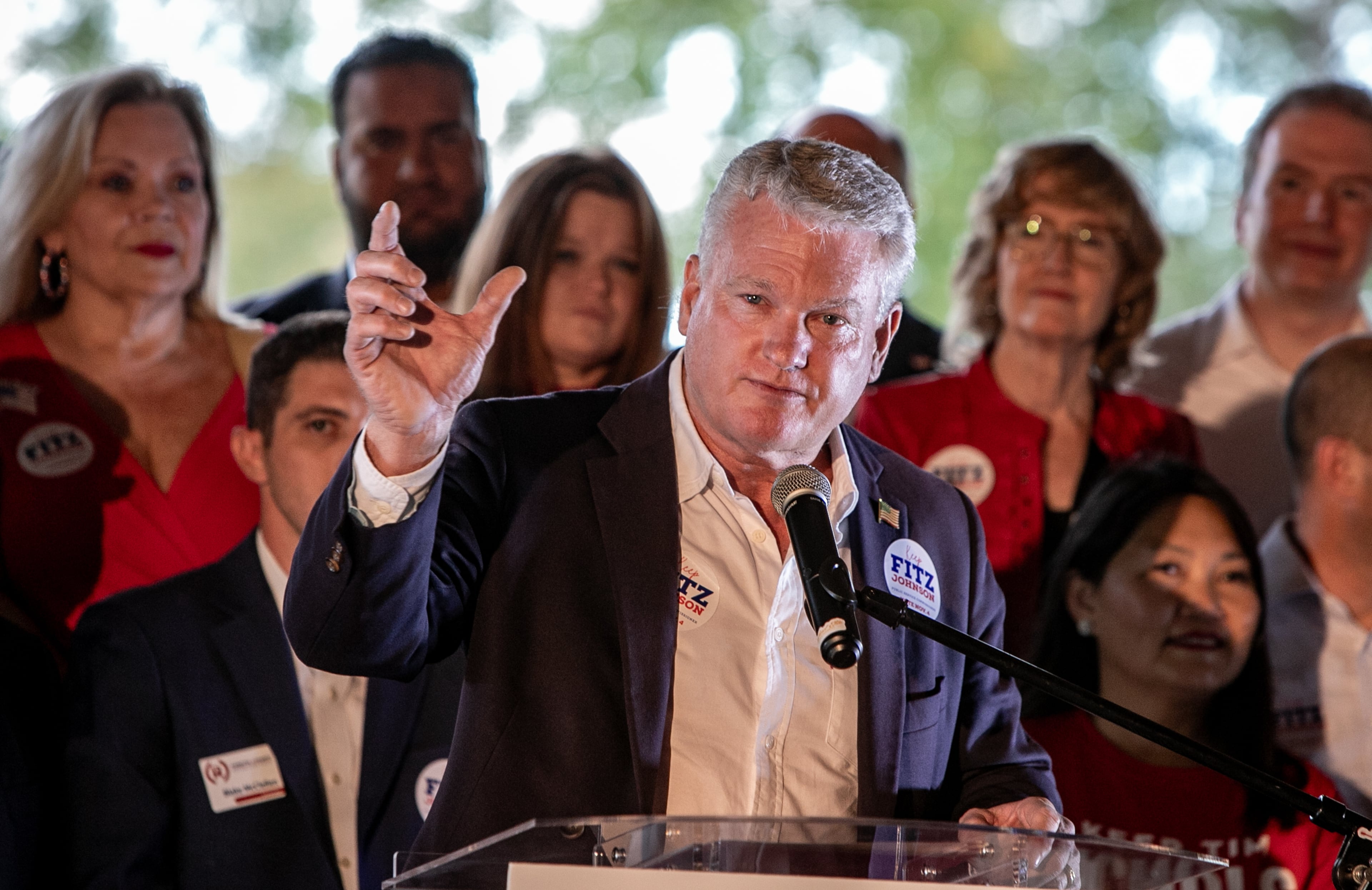 Commissioners Tim Echols and Fitz Johnson campaign with support from U.S. Rep. Mike Collins at a rally in Cumming at Reid Barn on Oct 7, 2025. (Jenni Girtman for the AJC)