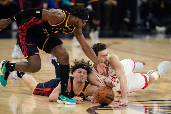From left, Golden State Warriors guards Buddy Hield and Brandin Podziemski compete for possession of the ball with Houston Rockets center Alperen Sengun during the first half of Game 4 of an NBA basketball first-round playoff series Monday, April 28, 2025, in San Francisco. (AP Photo/Godofredo A. Vásquez)