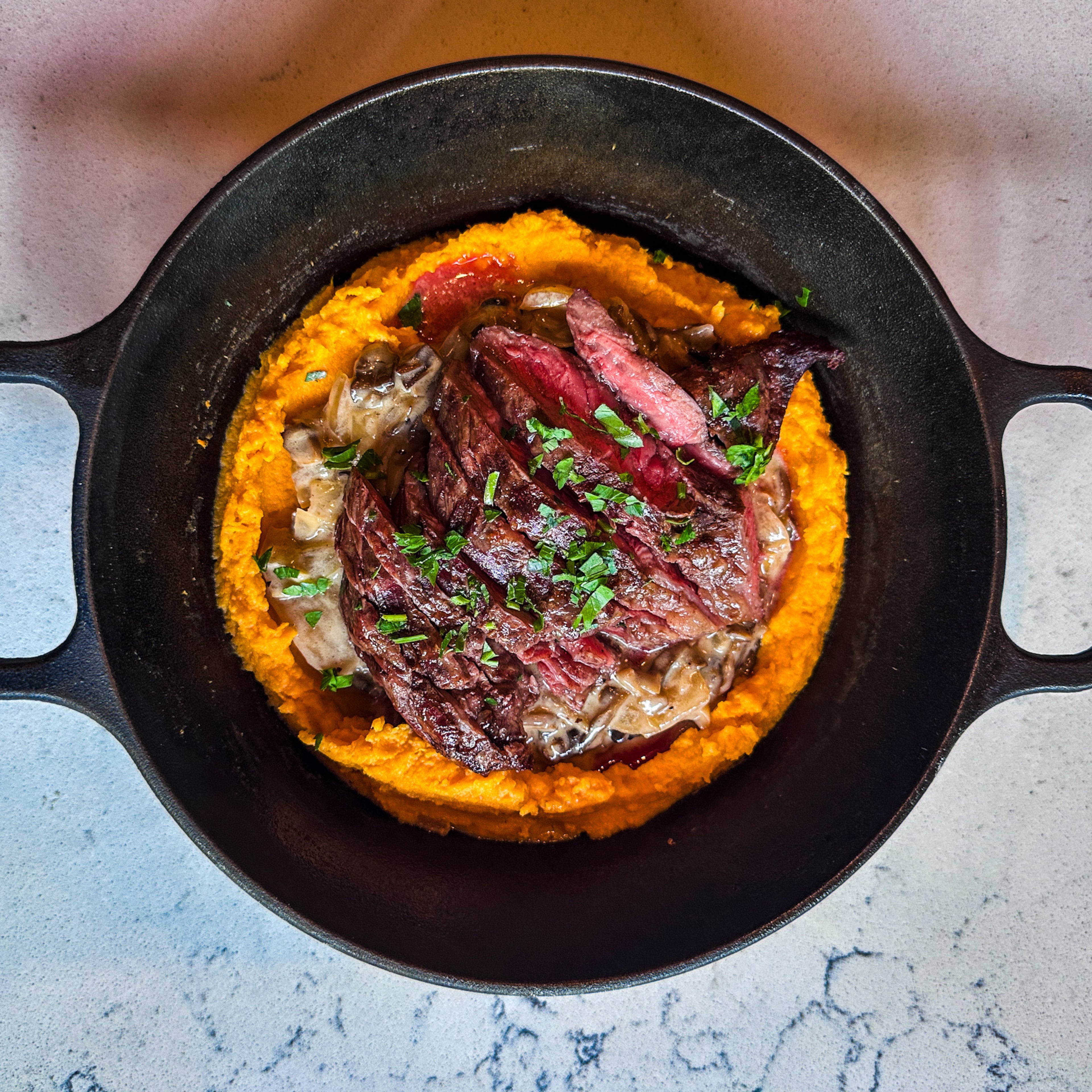 A weekend special at Belen Bistro features an Argentine cut of steak called vacio, served over mashed sweet potatoes with a mushroom sauce. (Courtesy of Belen Bistro & Market)