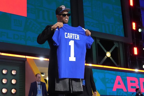 Penn State defensive end Abdul Carter poses after being chosen by the New York Giants with the third overall pick during the first round of the NFL football draft, Thursday, April 24, 2025, in Green Bay, Wis. (AP Photo/Jeff Roberson)