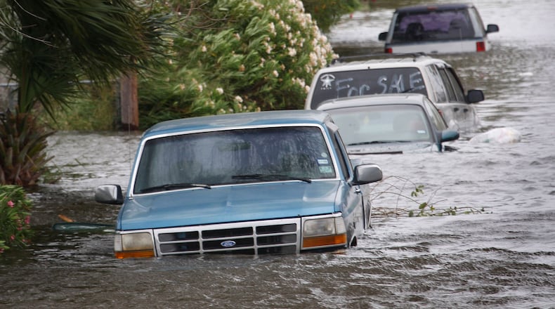 GALVESTON, TX - SEPTEMBER 12: Vehicles flooded by the tidal surge from Hurricane Ike sit along a street September 12, 2008 in Galveston, Texas. The eye of the hurricane is expected to make landfall at Galveston Island early Saturday morning. (Photo by Scott Olson/Getty Images)