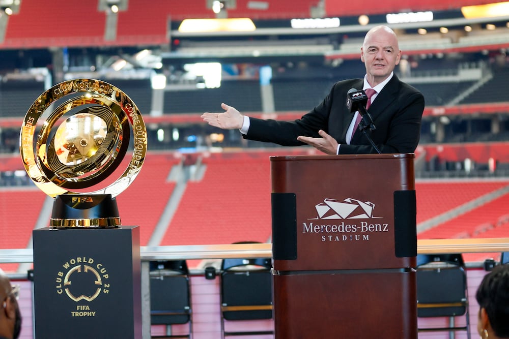 FIFA President Gianni Infantino gestures toward the Club World Cup trophy during an April news conference at Mercedes-Benz Stadium.