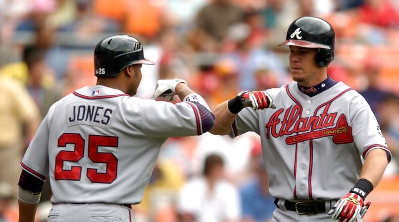 Andruw Jones (left) began a guest-instructor stint at Braves spring training Sunday, and Chipper Jones (right) is to be in camp Monday. (Getty Images)