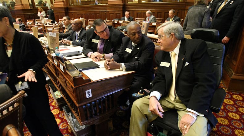 State Rep. Rusty Kidd, right, talks with Reps. Billy Mitchell, D-Stone Mountain, center, and Pedro “Pete” Marin, D-Duluth, during the 2012 legislative session. Kidd, an independent from Milledgeville, died Tuesday. Jason Getz jgetz@ajc.com