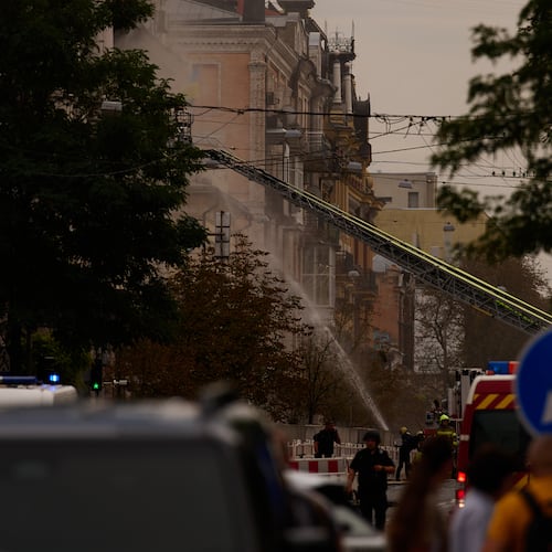 Firefighters work to extinguish a fire after a Russian drone attack struck a building in downtown Kyiv, Ukraine, Friday, Sept. 4, 2026. (AP Photo/Francisco Seco)