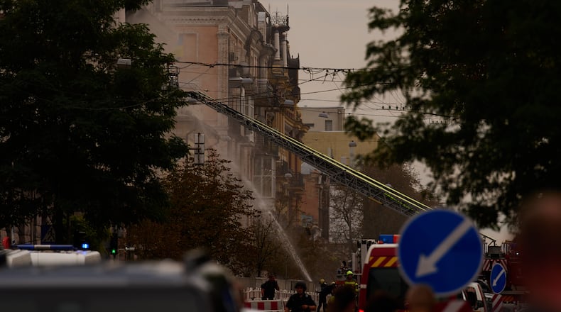 Firefighters work to extinguish a fire after a Russian drone attack struck a building in downtown Kyiv, Ukraine, Friday, Sept. 4, 2026. (AP Photo/Francisco Seco)